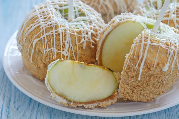 Caramel apple covered with white chocolate — Stock Photo, Image