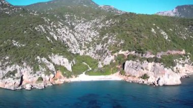 Turkuaz deniz suyu ve taş iskeleli güzel bir sahil manzarası. İtalya 'daki Sardunya adaları, insansız hava aracı atışı. Yaz deniz manzarası