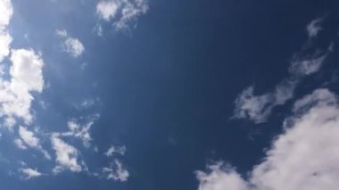 Beyaz sirrus bulutlarında parlayan parlak güneş ışınları ya da kümülüs bulutları üzerinde güneşli, açık mavi gökyüzü arka planında, B-roll Zaman Hızı.