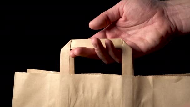 Man Opens Shows Paper Bag Black Background Security Black Friday — Stock Video
