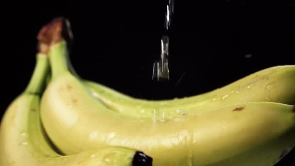 Banana Bunch Close Pouring Water Splashes Drops Black Background Slow — Stock Video