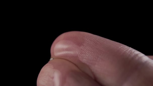 水滴落在起皱的食指上 在黑色背景上以慢动作飞溅 天然成份的卫生和保湿概念 — 图库视频影像
