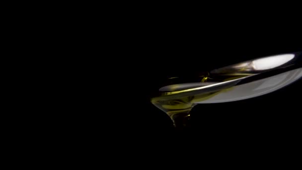 Golden Oil Poured Slow Motion Metal Dessert Spoon Macro Shot — Stockvideo