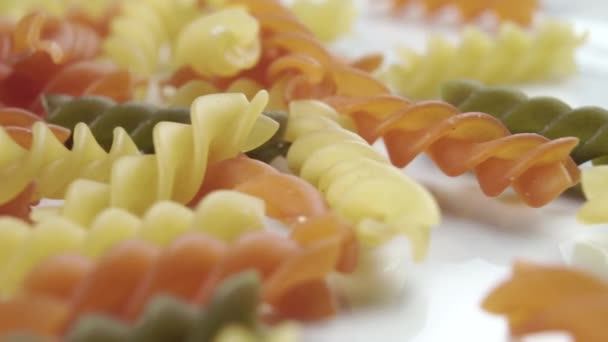 Colored Uncooked Pasta Spiral Shape Close White Plate Macro Dolly — Stock Video