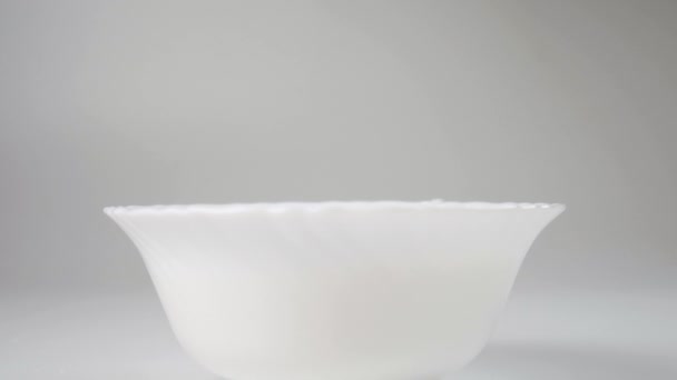 巧克力麦片球落在一碗牛奶中 动作缓慢 加满盘子的特写 煮脆片片 — 图库视频影像