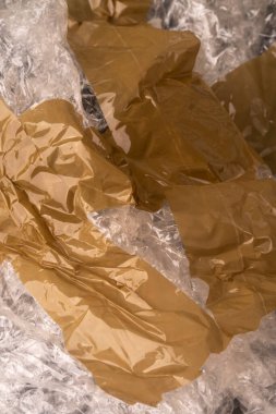 Crumpled wrinkled used packaging film close-up. Adhesive tape. Contamination with plastic waste concept