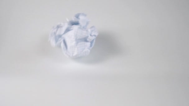 Thrown Crumpled Paper Ball Falls Rolls White Surface Slow Motion — Stock Video