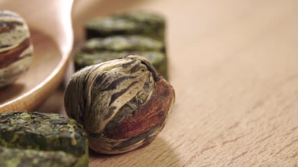 Green Tea Balls Flowers Jasmine Wooden Spoon Cutting Board Macro — Stock Video