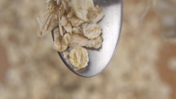 Raw Oatmeal Flakes Fall Metal Spoon Slow Motion Active View — Stock Video