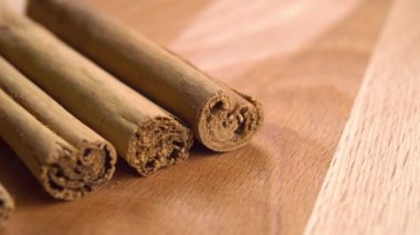 Cinnamon sticks on a wooden surface. Macro. Dolly shot.