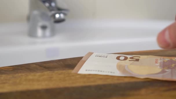 Fifty Euro Banknote Taken Hand Wooden Shelf Bathroom Sink Tap — Vídeo de Stock