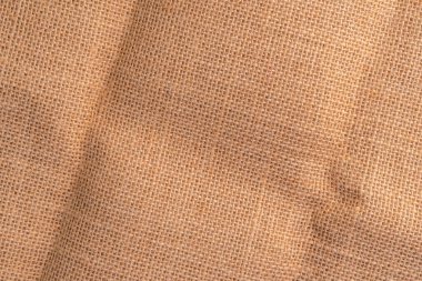 Kıvrımlı kıvrımlı kırsal kumaş ve kırışıklıklar. Yakın plan. Örgü arkaplan