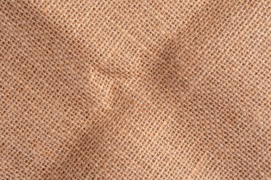 Kıvrımlı ve kırışıklıkları olan kırış kırış bir çuval bezi. Çuval bezi kabataslak. Kapatın. Boşluğu kopyala.