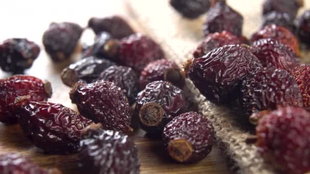 Dried Rose Hips Rustic Burlap Board Macro Dolly Shot — Stock Video