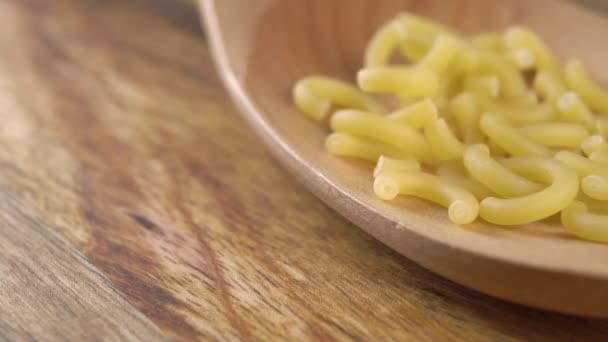 Falling Dry Uncooked Italian Gobbetti Pasta Kitchen Wooden Spoon Wood — Stock Video