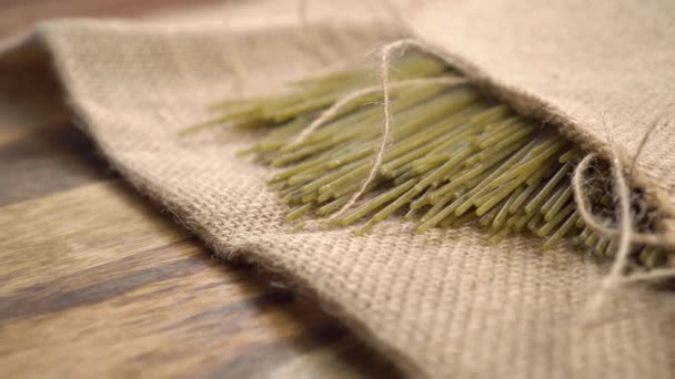 Green Vegetable Raw Pasta Rough Burlap Wooden Old Board Rustic — Stock Video