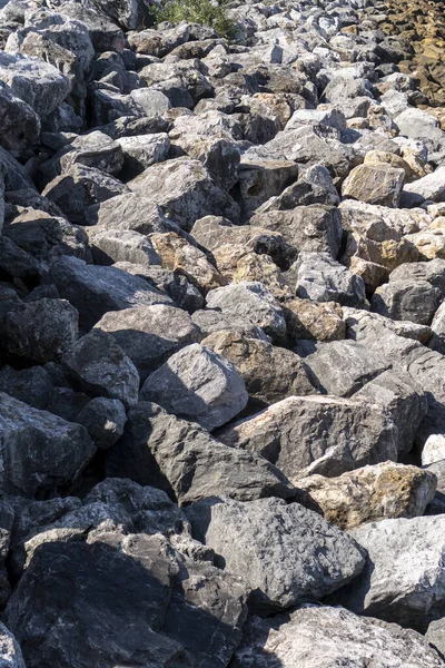 Rough piled stones close-up. Stony surface