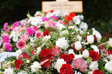 colorful flowers on a grave after a funeral clipart