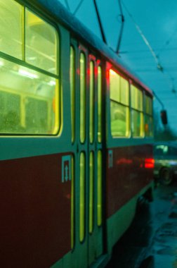 Alacakaranlık aydınlatmalı eski tramvay caddede ilerliyor, Kiev, Ukrayna