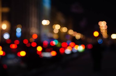 Gece şehir trafik ışıklarının odaklanmamış görüntüsü