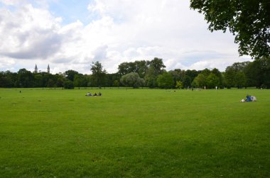 green lawn in park with resting people