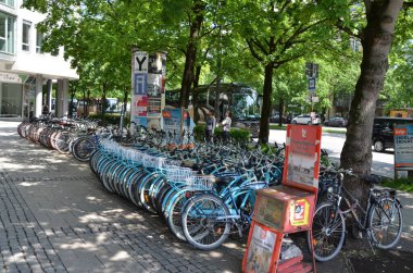 view of blue bicycles parked in city scene