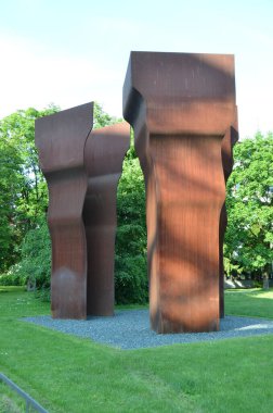 large metal sculptures in green park scene