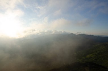 Bulutlu gökyüzü ile dağlık manzaranın güzel manzarası