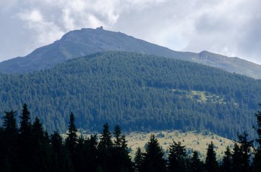 Bulutlu gökyüzü ile dağlık manzaranın güzel manzarası