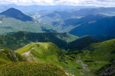 Bulutlu gökyüzü ile dağlık manzaranın güzel manzarası