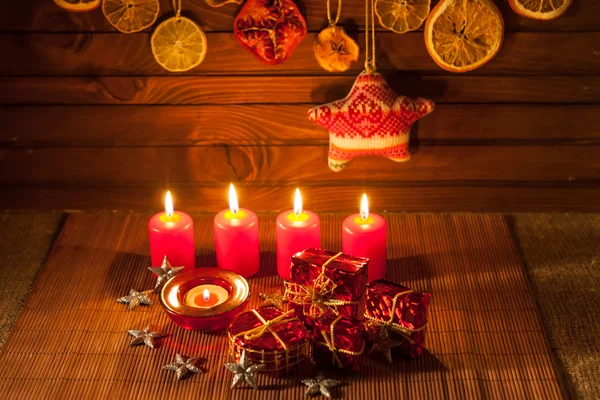 Image of Christmas decorations, candles, gifts on brown background — Stock Photo, Image