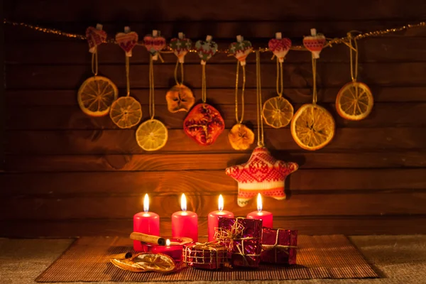 Image of Christmas decorations, candles, gifts on brown background — Stock Photo, Image