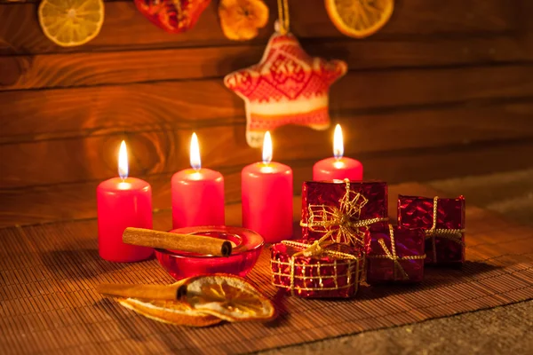 Image of Christmas decorations, candles, gifts on brown background — Stock Photo, Image