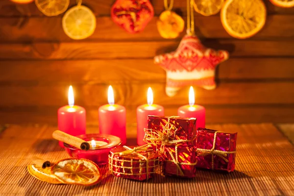 Image of Christmas decorations, candles, gifts on brown background — Stock Photo, Image