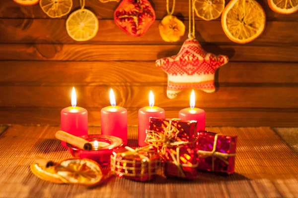 Image of Christmas decorations, candles, gifts on brown background — Stock Photo, Image