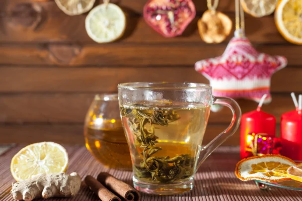 Ginger tea with spices, honey, cinnamon, lemon and dried fruit on a linen background — Stock Photo, Image