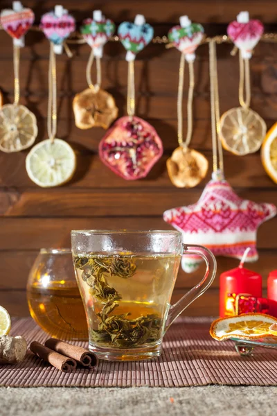 Ginger tea with spices, honey, cinnamon, lemon and dried fruit on a linen background — Stock Photo, Image