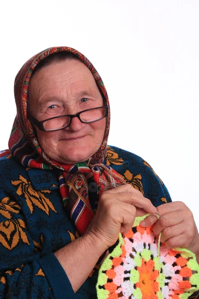 The elderly woman, knitting the napkin — Stock Photo, Image