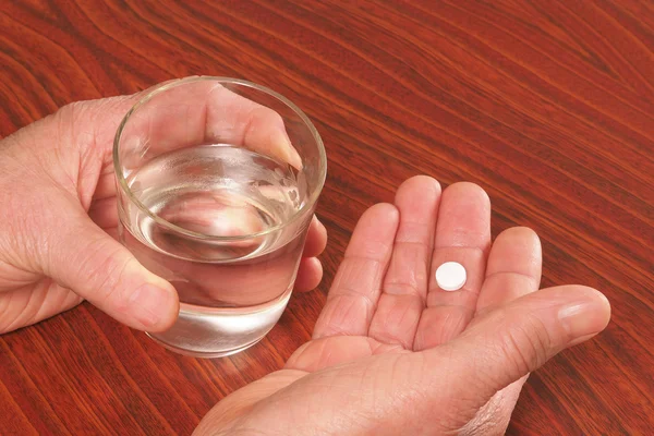 Tablet and glass in hands — Stock Photo, Image