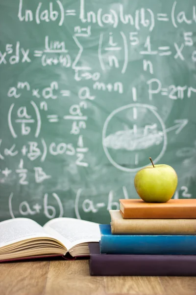 Handwriting blackboard with stack of books — Stock Photo, Image