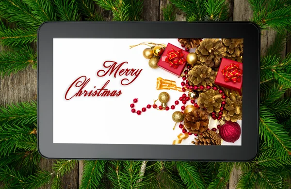 Christmas tablet on tree brunch — Stock Photo, Image