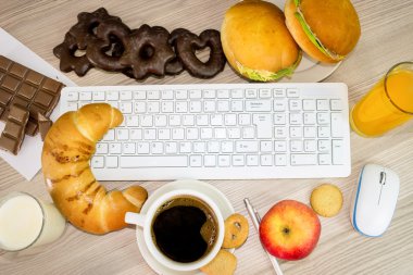 keyboard covered with food that we eat during work clipart