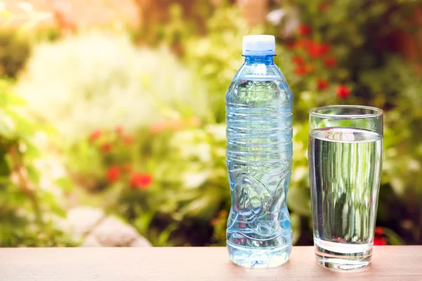 Fles met zoet water op zonnige dag Stockfoto