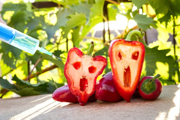 Bell pepper next to a syringe against — Stock Photo, Image