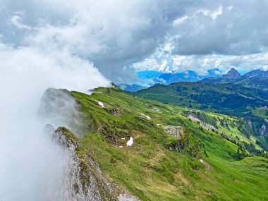Miraculous low clouds and a mystical fog of the mountain range First and in the Schwyz Alps mountain massif, Oberiberg - Canton of Schwyz, Switzerland (Kanton Schwyz, Schweiz)