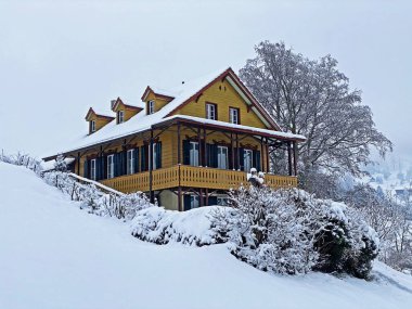Idyllic Swiss alpine mountain huts and traditional Swiss rural architecture dressed in winter clothes and in a fresh snow cover on the slopes of Mountain Rigi, Weggis - Canton of Lucerne, Switzerland (Schweiz)