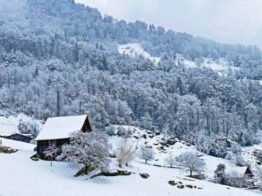 Idyllic Swiss alpine mountain huts and traditional Swiss rural architecture dressed in winter clothes and in a fresh snow cover on the slopes of Mountain Rigi, Weggis - Canton of Lucerne, Switzerland (Schweiz)