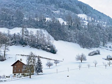Idyllic Swiss alpine mountain huts and traditional Swiss rural architecture dressed in winter clothes and in a fresh snow cover on the slopes of Mountain Rigi, Weggis - Canton of Lucerne, Switzerland (Schweiz)