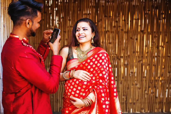 Indian Man Photographing His Pregnant Wife Wearing Saree Mobile Phone Royalty Free Stock Photos