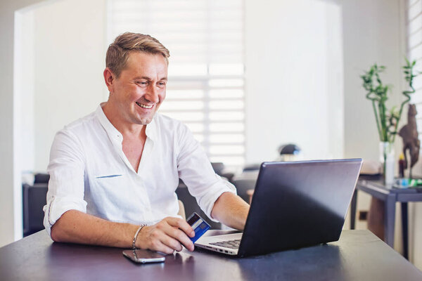 Handsome Caucasian Man Working Home House Sitting Table While Using Royalty Free Stock Images
